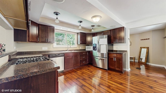 914 Ski Hill Rd, Fox River Grove, IL 60021 - kitchen with stainless steel appliances, dark countertops, dark wood-type flooring, and a raised ceiling