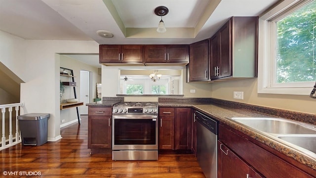 914 Ski Hill Rd, Fox River Grove, IL 60021 - kitchen featuring appliances with stainless steel finishes, dark countertops, dark wood-type flooring, a chandelier, and a raised ceiling