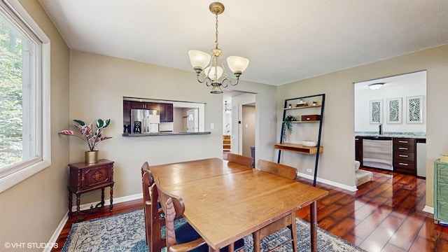 914 Ski Hill Rd, Fox River Grove, IL 60021 - dining space featuring dark wood finished floors, healthy amount of natural light, and a chandelier