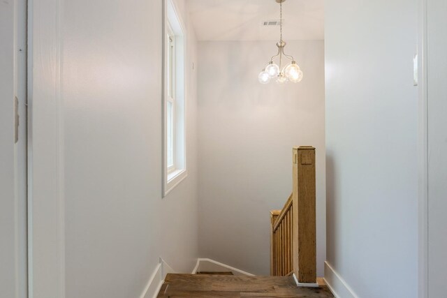 223 W 118th St, Chicago, IL 60628 - stairs with a chandelier and baseboards