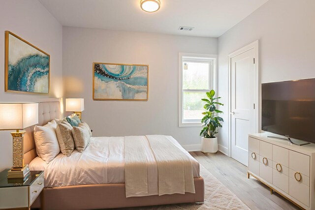 223 W 118th St, Chicago, IL 60628 - bedroom with light wood finished floors and baseboards