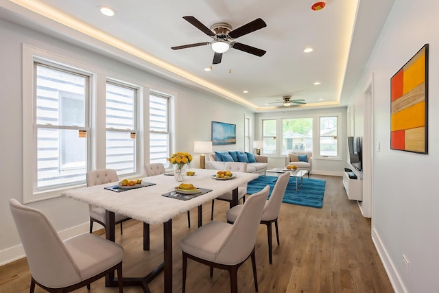 223 W 118th St, Chicago, IL 60628 - dining space with ceiling fan, baseboards, a tray ceiling, recessed lighting, and light wood-style floors