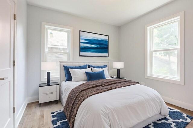 223 W 118th St, Chicago, IL 60628 - bedroom featuring multiple windows, light wood finished floors, and baseboards