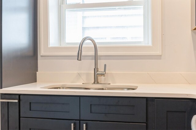 223 W 118th St, Chicago, IL 60628 - kitchen view of a sink, gray cabinets, and light stone counters