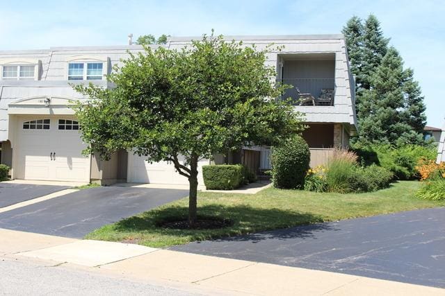 642 Burgundy Ct Unit A, Elk Grove Village, IL 60007 - view of property with a garage, asphalt driveway, a front yard, and stucco siding