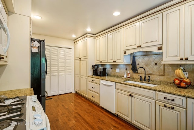 642 Burgundy Ct Unit A, Elk Grove Village, IL 60007 - kitchen featuring white dishwasher, freestanding refrigerator, decorative backsplash, wood finished floors, and cream cabinetry
