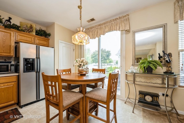 12140 Hideaway Dr, Huntley, IL 60142 - dining space featuring healthy amount of natural light, light tile patterned flooring, and a chandelier