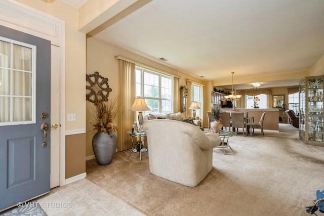 12140 Hideaway Dr, Huntley, IL 60142 - living room featuring healthy amount of natural light, a chandelier, and light colored carpet