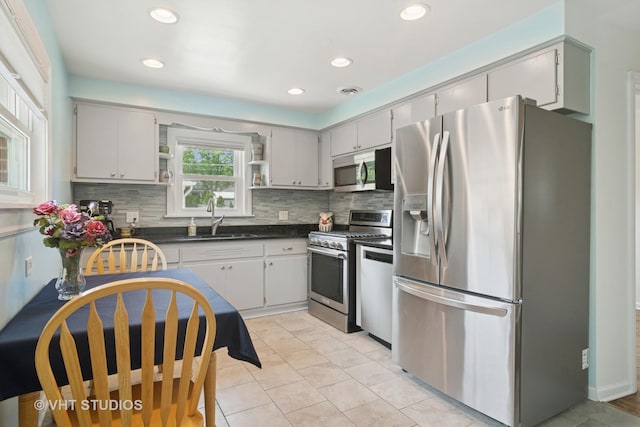 530 S Mitchell Ave, Arlington Heights, IL 60005 - kitchen featuring appliances with stainless steel finishes, open shelves, dark countertops, decorative backsplash, and recessed lighting