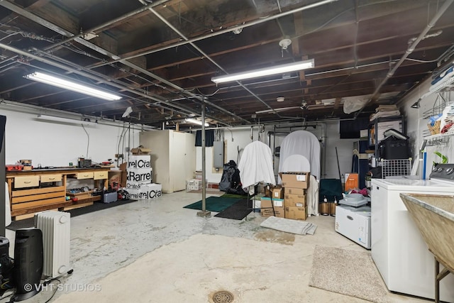 207 S Van Buren St, East Dundee, IL 60118 - unfinished basement featuring electric panel, a workshop area, separate washer and dryer, and radiator