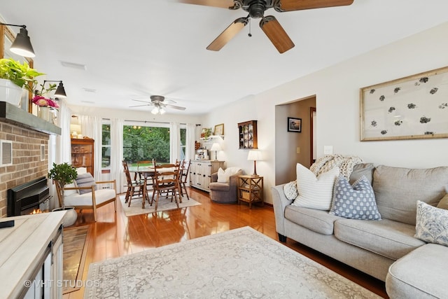207 S Van Buren St, East Dundee, IL 60118 - living area with ceiling fan, light wood-style floors, and a brick fireplace