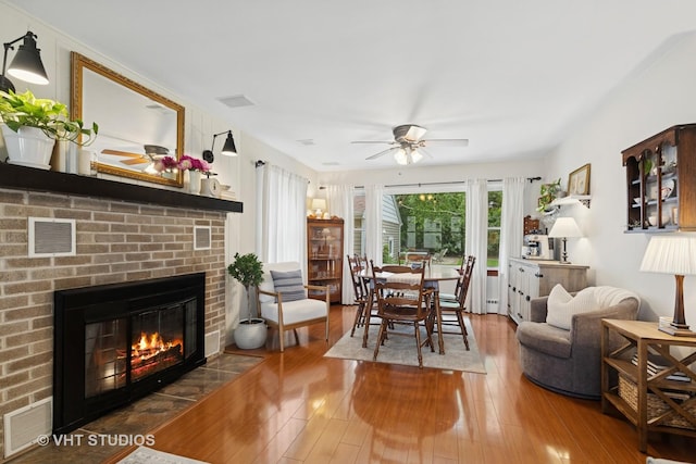 207 S Van Buren St, East Dundee, IL 60118 - dining room featuring ceiling fan, hardwood / wood-style floors, and a fireplace
