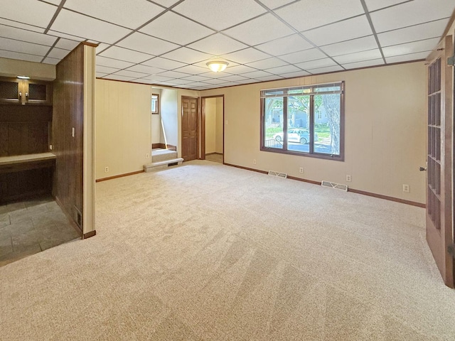 111 E Roosevelt St, Freeport, IL 61032 - unfurnished living room with baseboards, carpet floors, and a drop ceiling