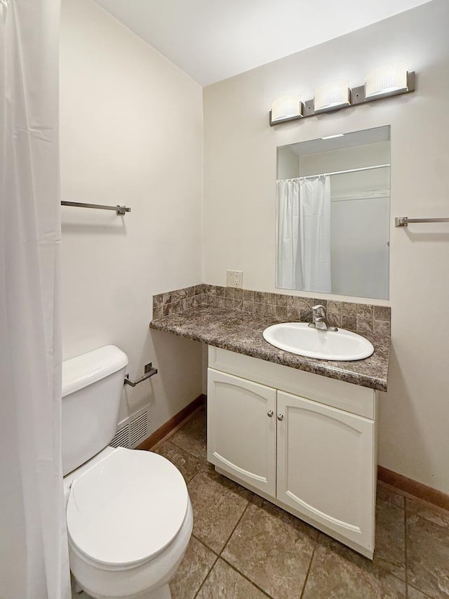 111 E Roosevelt St, Freeport, IL 61032 - bathroom with vanity, baseboards, toilet, and tile patterned floors