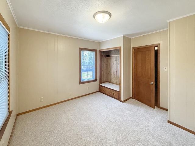 111 E Roosevelt St, Freeport, IL 61032 - unfurnished bedroom featuring carpet flooring, crown molding, a closet, and baseboards