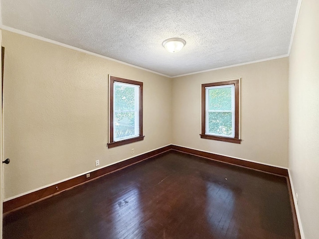 111 E Roosevelt St, Freeport, IL 61032 - empty room featuring healthy amount of natural light, dark wood-type flooring, a textured ceiling, crown molding, and baseboards