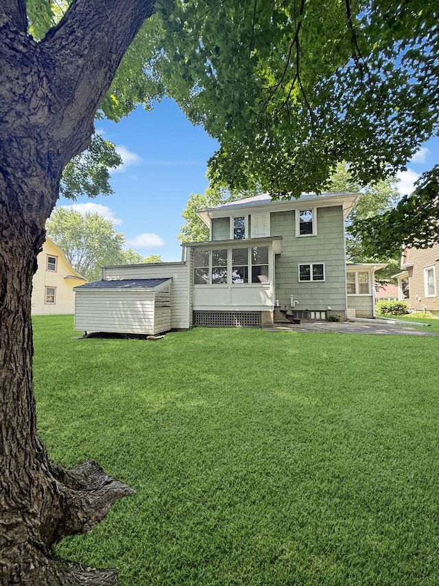 111 E Roosevelt St, Freeport, IL 61032 - back of property with a yard and a sunroom