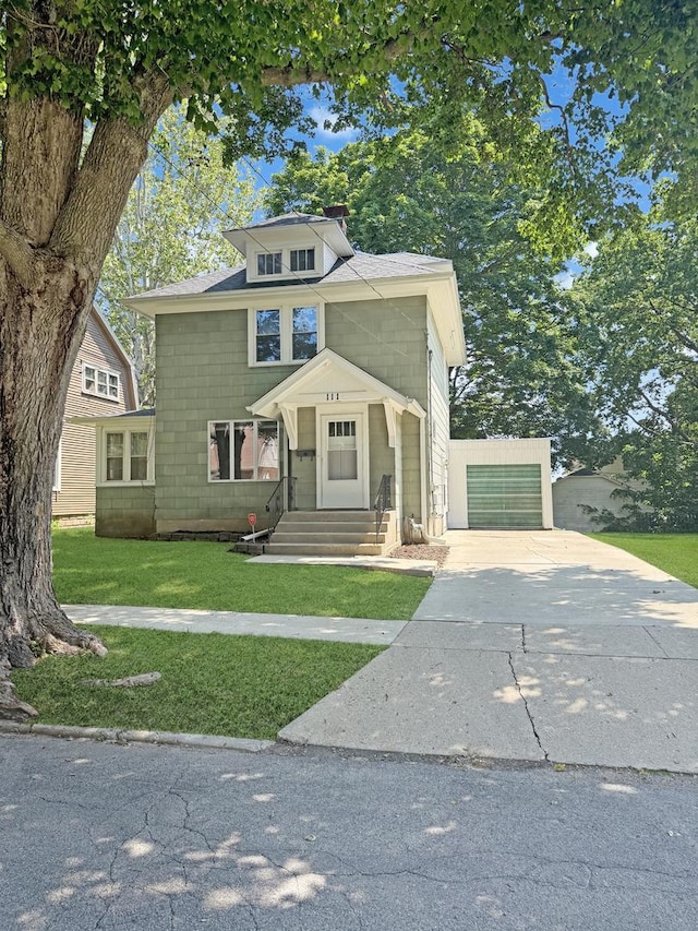 111 E Roosevelt St, Freeport, IL 61032 - american foursquare style home with concrete driveway, a chimney, a front lawn, entry steps, and a garage