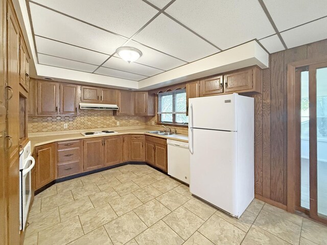 111 E Roosevelt St, Freeport, IL 61032 - kitchen with white appliances, under cabinet range hood, light countertops, a sink, and tasteful backsplash
