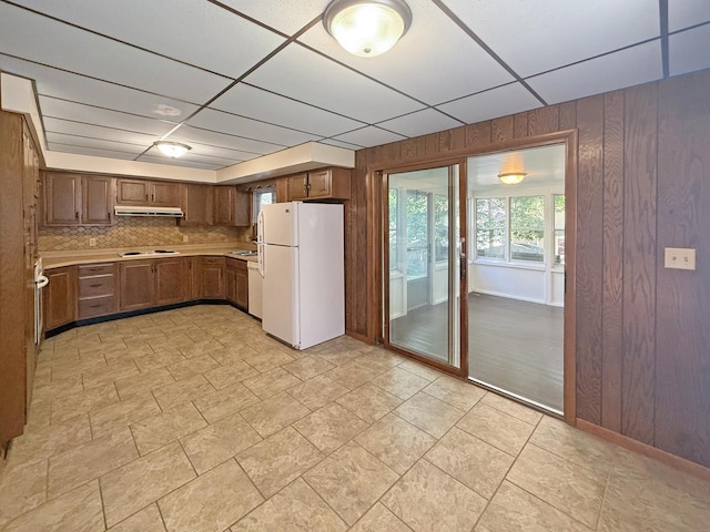 111 E Roosevelt St, Freeport, IL 61032 - kitchen with white appliances, wooden walls, light countertops, a drop ceiling, and decorative backsplash