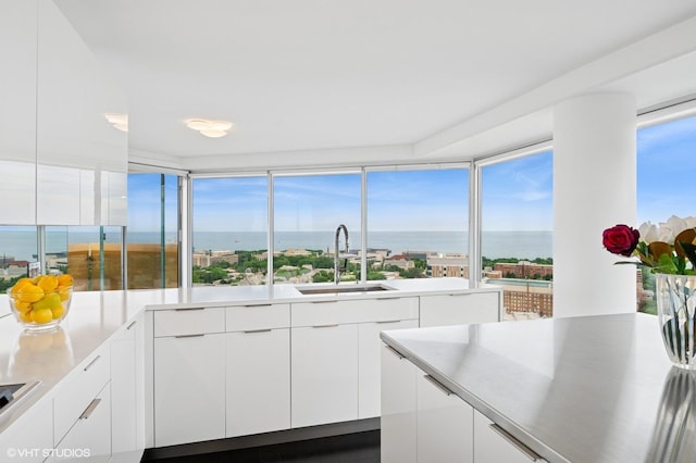 1720 Maple Ave Unit 2710, Evanston, IL 60201 - kitchen featuring modern cabinets, white cabinetry, a water view, light countertops, and healthy amount of natural light
