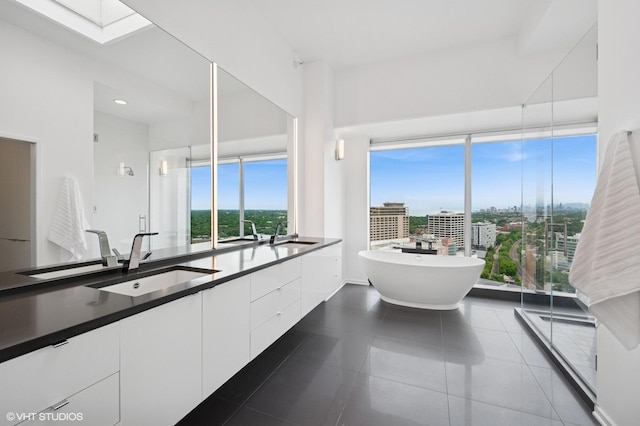 1720 Maple Ave Unit 2710, Evanston, IL 60201 - full bathroom with double vanity, a soaking tub, tile patterned flooring, and a skylight