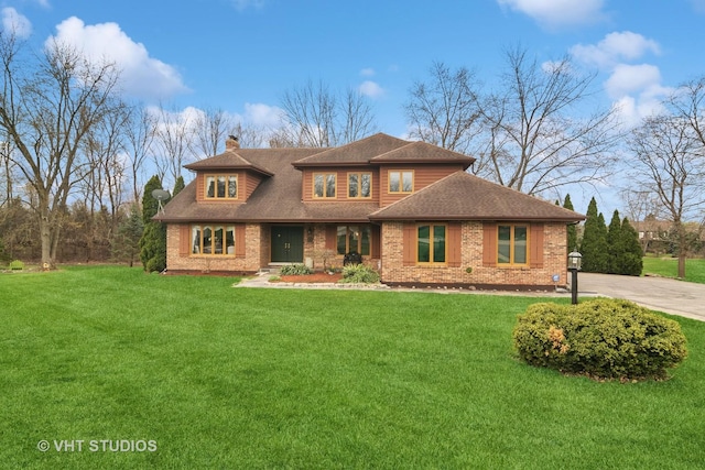 1422 Kirkwall Ct, Inverness, IL 60010 - view of front facade with a chimney, brick siding, a front yard, and a shingled roof