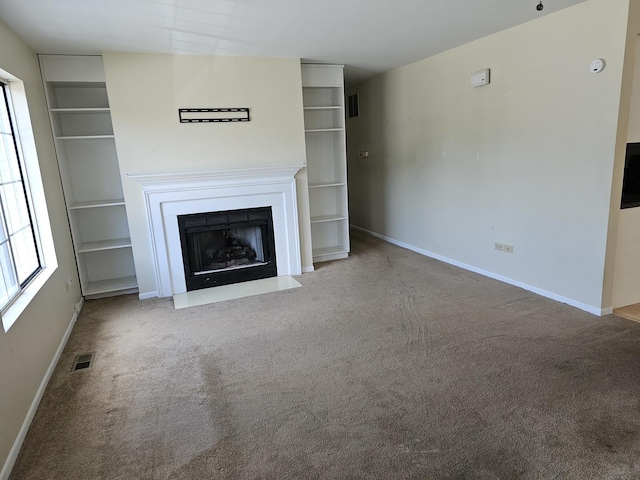 2135 Colorado Ave Unit 2135, Elgin, IL 60123 - unfurnished living room with carpet floors, a fireplace with flush hearth, and built in features