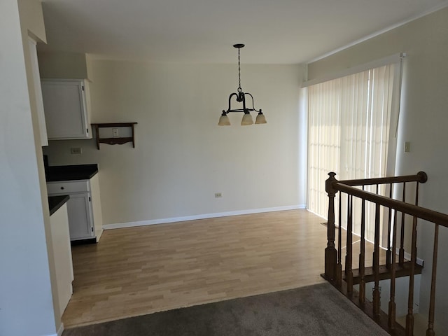 2135 Colorado Ave Unit 2135, Elgin, IL 60123 - unfurnished dining area with a chandelier and light wood-style floors