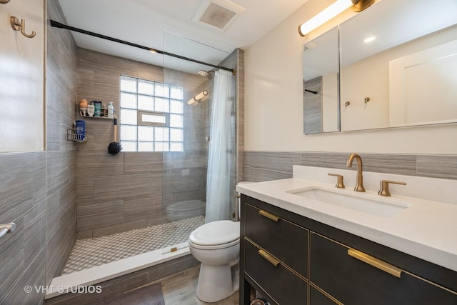 1019 Lyman Ave, Oak Park, IL 60304 - bathroom featuring tile walls, vanity, and tiled shower