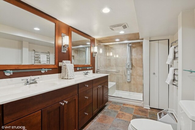 739 Jackson Ave, River Forest, IL 60305 - bathroom featuring double vanity, a shower stall, recessed lighting, and stone finish flooring