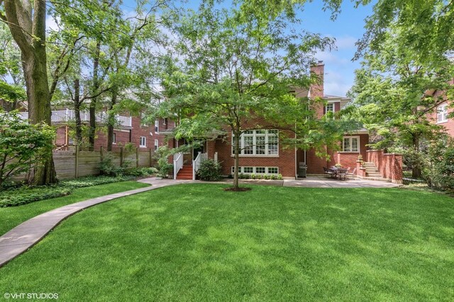 739 Jackson Ave, River Forest, IL 60305 - rear view of property with a yard, brick siding, a chimney, and a patio area