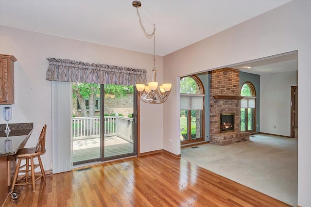82 Whisper Creek Dr, New Lenox, IL 60451 - unfurnished dining area with a chandelier, plenty of natural light, and light wood-style flooring