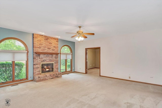 82 Whisper Creek Dr, New Lenox, IL 60451 - unfurnished living room with light carpet, a ceiling fan, and a fireplace