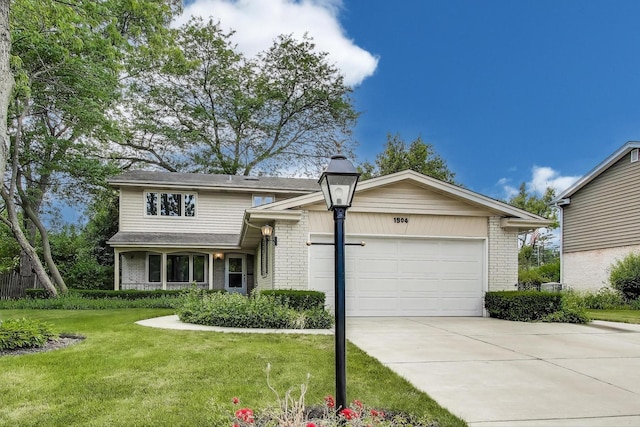 1904 Birch Rd, Northbrook, IL 60062 - view of front of home featuring concrete driveway, brick siding, an attached garage, and a front yard