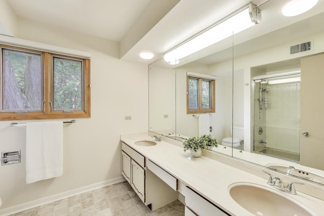1904 Birch Rd, Northbrook, IL 60062 - bathroom featuring healthy amount of natural light, double vanity, and shower / bath combination with glass door