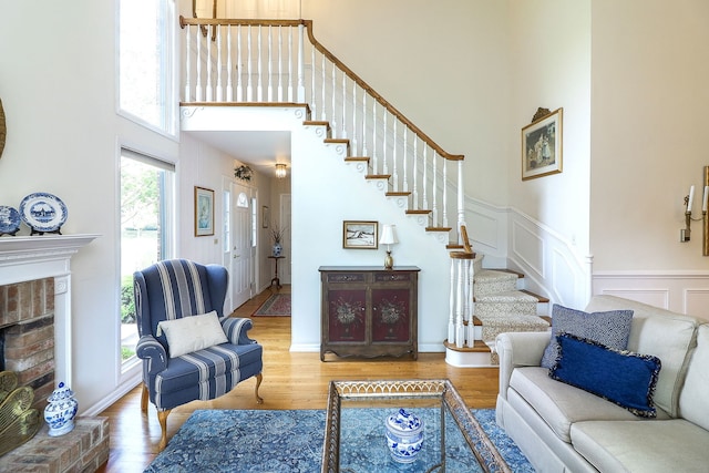 12 Kyle Ct, Willowbrook, IL 60527 - living room with a high ceiling, stairs, wood finished floors, a fireplace, and a decorative wall