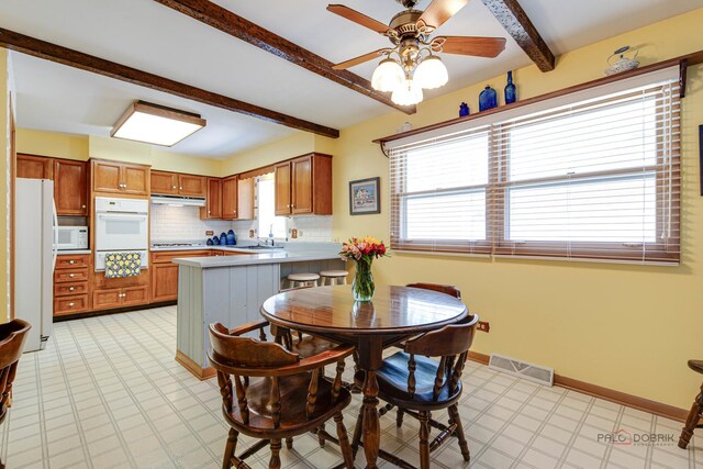 1103 S Belmont Ave, Arlington Heights, IL 60005 - dining space featuring beam ceiling, a ceiling fan, and light floors