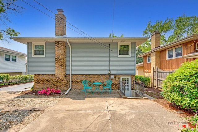 1103 S Belmont Ave, Arlington Heights, IL 60005 - back of house with brick siding, a patio area, and a chimney