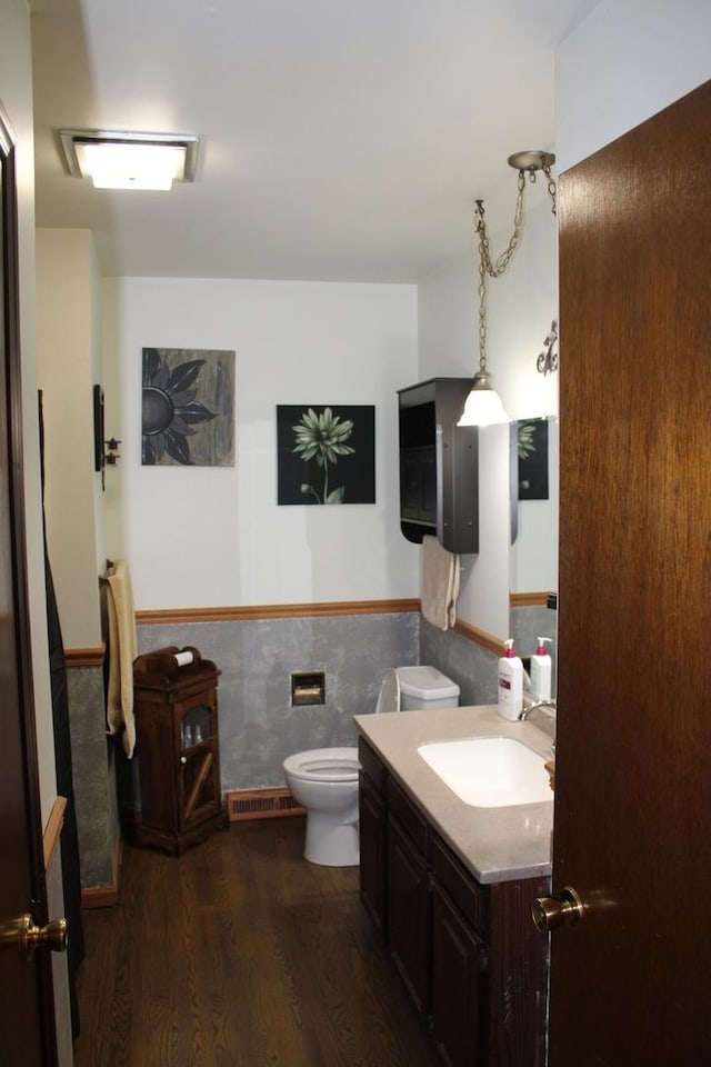 907 N Eddy St, Sandwich, IL 60548 - bathroom featuring vanity, a wainscoted wall, wood finished floors, and toilet