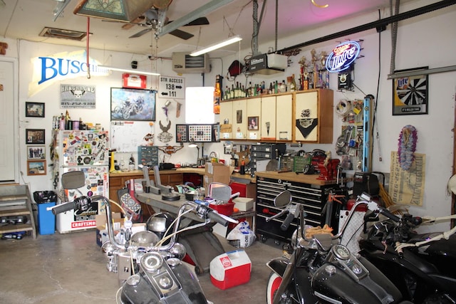 907 N Eddy St, Sandwich, IL 60548 - garage with a workshop area, a ceiling fan, a garage door opener, and a heating unit