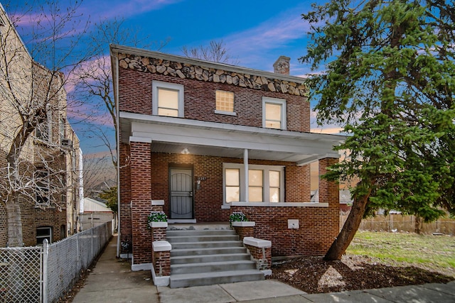 11357 S Indiana Ave, Chicago, IL 60628 - view of front facade with a chimney, brick siding, and covered porch