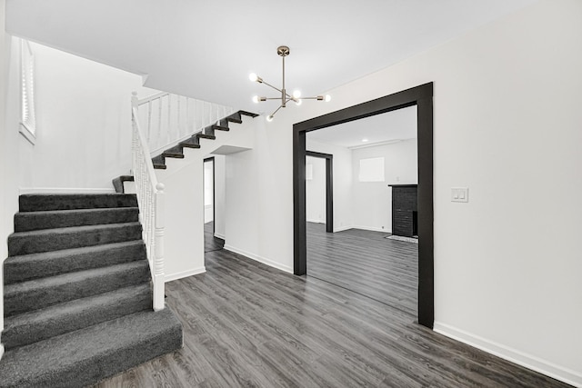 11357 S Indiana Ave, Chicago, IL 60628 - stairs with wood finished floors and a chandelier