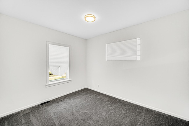 11357 S Indiana Ave, Chicago, IL 60628 - spare room with baseboards and dark colored carpet