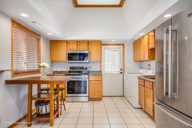 1N559 Newton Ave, Glen Ellyn, IL 60137 - kitchen with appliances with stainless steel finishes, washing machine and dryer, recessed lighting, and light tile patterned floors