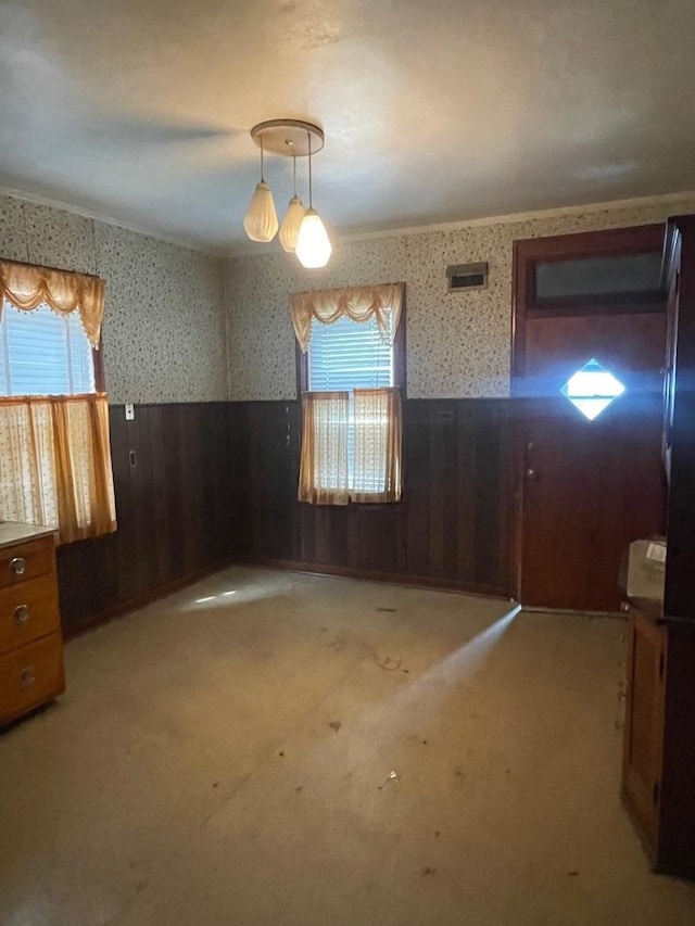 8626 S Burnham Ave, Chicago, IL 60617 - unfurnished room with a wainscoted wall, wallpapered walls, healthy amount of natural light, wooden walls, and light colored carpet