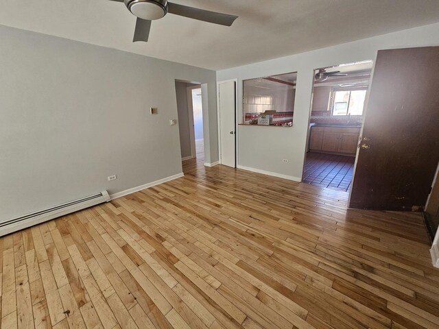 5349 N Delphia Ave Unit 150, Chicago, IL 60656 - spare room with a ceiling fan, wood-type flooring, baseboard heating, and baseboards
