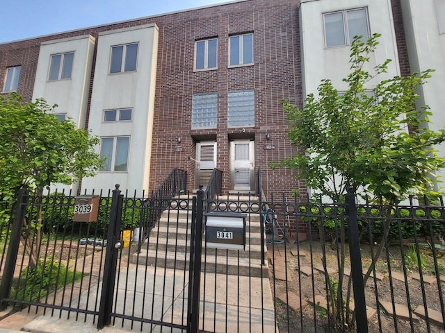 3041 W Pope John Paul Ii Dr, Chicago, IL 60638 - view of front facade with a fenced front yard, brick siding, and a gate