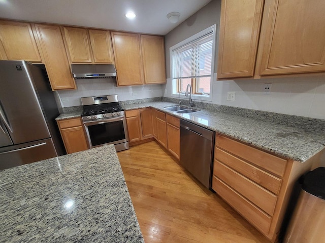 3041 W Pope John Paul Ii Dr, Chicago, IL 60638 - kitchen with stainless steel appliances, a sink, extractor fan, light wood-style flooring, and light stone counters