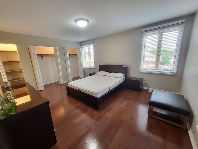 3041 W Pope John Paul Ii Dr, Chicago, IL 60638 - bedroom featuring multiple closets, dark wood-style flooring, and baseboards
